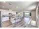 Open-concept kitchen flows into the living area, featuring a large island and modern appliances at 8629 Ensworth St # 114, Las Vegas, NV 89123