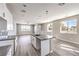 Modern kitchen features stainless steel appliances, gray countertops, and sleek white cabinetry at 8629 Ensworth St # 114, Las Vegas, NV 89123