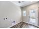 Clean laundry room featuring vinyl flooring, utility connections, and a glass panel back door at 8629 Ensworth St # 114, Las Vegas, NV 89123