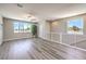 Bright and airy living area with large windows, modern ceiling fan, and railing, providing ample natural light and comfortable living at 8629 Ensworth St # 114, Las Vegas, NV 89123