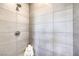 Modern shower featuring sleek tilework, a shower head, and built in bench at 8629 Ensworth St # 114, Las Vegas, NV 89123