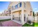 View of backyard featuring a covered patio, artificial turf, access to the yard and homes behind at 8798 Tom Noon Ave # 103, Las Vegas, NV 89178