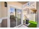 A sliding glass door leads to backyard patio with artificial turf and an air conditioning unit nearby at 8798 Tom Noon Ave # 103, Las Vegas, NV 89178
