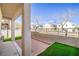 Backyard featuring a small patio, artificial grass, and block wall at 8798 Tom Noon Ave # 103, Las Vegas, NV 89178