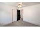 Cozy bedroom with neutral carpet, white walls, ceiling fan, and closet doors at 8798 Tom Noon Ave # 103, Las Vegas, NV 89178
