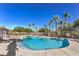 Community pool with clear blue water, surrounded by palm trees and lounge seating at 8798 Tom Noon Ave # 103, Las Vegas, NV 89178