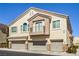Well-kept townhome featuring a three-car garage, second story balcony, and stucco facade at 8798 Tom Noon Ave # 103, Las Vegas, NV 89178