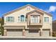 Inviting multi-level townhome with three-car garage, balcony, and neutral-toned stucco exterior at 8798 Tom Noon Ave # 103, Las Vegas, NV 89178