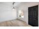 Bright, modern room features light-colored hardwood floors, a large window, and minimalist design at 8798 Tom Noon Ave # 103, Las Vegas, NV 89178