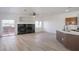 Spacious living area with hardwood floors, fireplace, and sliding doors to an outdoor patio at 8798 Tom Noon Ave # 103, Las Vegas, NV 89178
