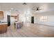 Large, open living room with hardwood floors, ceiling fan, kitchen, and updated lighting at 8798 Tom Noon Ave # 103, Las Vegas, NV 89178