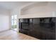 Bright living room with modern fireplace and sliding glass door to the backyard at 8798 Tom Noon Ave # 103, Las Vegas, NV 89178