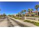 Arlington Ranch community entrance, a tree-lined street with well maintained desert landscaping at 8798 Tom Noon Ave # 103, Las Vegas, NV 89178