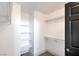 Bright, clean walk-in closet with built-in shelving and hanging rods at 8798 Tom Noon Ave # 103, Las Vegas, NV 89178
