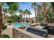 Entertainers backyard featuring a large pool, built in BBQ and bar area, and lush landscaping for a private retreat at 9108 Ghost Mountain Ave, Las Vegas, NV 89129
