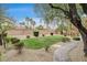Expansive backyard featuring manicured landscaping, mature trees, and a charming stone pathway at 9108 Ghost Mountain Ave, Las Vegas, NV 89129