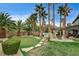 Backyard with a fire pit, mature landscaping, and putting green, perfect for outdoor activities and relaxing at 9108 Ghost Mountain Ave, Las Vegas, NV 89129
