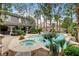 Aerial view of the backyard with a pool, spa, covered patio, and lush landscaping, perfect for outdoor living at 9108 Ghost Mountain Ave, Las Vegas, NV 89129