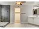 Bathroom featuring a walk in shower, vanity with sink, a walk in closet, and tile flooring at 9108 Ghost Mountain Ave, Las Vegas, NV 89129