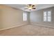 Bright bedroom features neutral carpeting, ceiling fan, and plantation shutters at 9108 Ghost Mountain Ave, Las Vegas, NV 89129