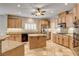 Updated kitchen featuring granite countertops, stainless steel appliances, custom cabinets, and tiled floors for a luxurious cooking experience at 9108 Ghost Mountain Ave, Las Vegas, NV 89129