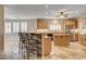 Elegant kitchen boasts a spacious layout, modern appliances, breakfast bar, and stylish travertine floors, blending functionality with style at 9108 Ghost Mountain Ave, Las Vegas, NV 89129