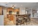Bright kitchen with an island, wooden cabinets, granite countertops, and stainless steel appliances at 9108 Ghost Mountain Ave, Las Vegas, NV 89129