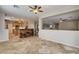 Spacious living room with tile floors, neutral walls, and an open concept design leading to the kitchen at 9108 Ghost Mountain Ave, Las Vegas, NV 89129
