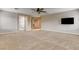 Spacious living room featuring neutral walls, carpet floors, and a ceiling fan provides a cozy and comfortable atmosphere at 9108 Ghost Mountain Ave, Las Vegas, NV 89129