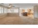 Open concept design living room showcasing plantation shutters and seamless transitions into the kitchen with a breakfast bar at 9108 Ghost Mountain Ave, Las Vegas, NV 89129