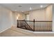 Upstairs loft area with a dark wood banister and a view to other rooms creates an open and inviting space at 9108 Ghost Mountain Ave, Las Vegas, NV 89129