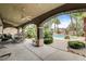 Elegant outdoor living space with covered patio, dining area, and a refreshing pool surrounded by tropical foliage at 9108 Ghost Mountain Ave, Las Vegas, NV 89129