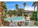 Backyard with a pool, spa, and lush tropical landscaping, offering a private and serene outdoor escape at 9108 Ghost Mountain Ave, Las Vegas, NV 89129