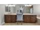 This bathroom features double sinks, wood cabinets, a large mirror, and a separate shower stall at 9475 Castillana Ct, Las Vegas, NV 89147