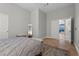 Clean bedroom features a bed with a bench and a view of a landing leading to an additional room at 9475 Castillana Ct, Las Vegas, NV 89147