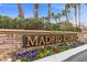 Madrid Estates sign with colorful flowers and palm trees in the background on a sunny day at 9475 Castillana Ct, Las Vegas, NV 89147