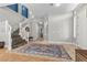 Elegant foyer with staircase, neutral walls, decorative rug, and natural light at 9475 Castillana Ct, Las Vegas, NV 89147