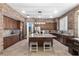 Gourmet kitchen with granite countertops, a large island, stainless steel appliances and stone accents at 9475 Castillana Ct, Las Vegas, NV 89147