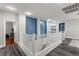 Bright upper landing with white railings and views into other rooms. Hardwood floors create a cozy landing space at 9475 Castillana Ct, Las Vegas, NV 89147