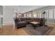 Comfortable living room with a sectional gray couch, wooden coffee table, and views of the outdoor patio area at 9475 Castillana Ct, Las Vegas, NV 89147