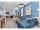 Bright living room with blue accent wall, modern lighting, plush sectional sofa, and elegant rug at 9475 Castillana Ct, Las Vegas, NV 89147