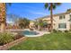 Inviting backyard pool featuring a tropical landscape and outdoor living space with a cozy cabana at 9475 Castillana Ct, Las Vegas, NV 89147
