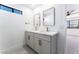 Modern bathroom featuring double sinks, quartz countertops, and gold hardware at 1009 N Tenaya Way, Las Vegas, NV 89128
