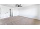Spacious bedroom with modern ceiling fan, neutral carpet and closet access at 1009 N Tenaya Way, Las Vegas, NV 89128