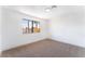 Bedroom featuring neutral carpet, a large window, and a modern ceiling light at 1009 N Tenaya Way, Las Vegas, NV 89128