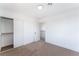 Neutral bedroom featuring neutral carpet, closet, and a modern ceiling light at 1009 N Tenaya Way, Las Vegas, NV 89128