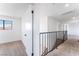 Hallway featuring neutral carpet and a metal railing overlooking the stairs at 1009 N Tenaya Way, Las Vegas, NV 89128