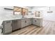 Bright kitchen with stainless steel appliances, white cabinets, light countertops, and wood-look floors at 1009 N Tenaya Way, Las Vegas, NV 89128