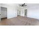 Large main bedroom featuring neutral carpet, walk-in closet and bathroom access at 1009 N Tenaya Way, Las Vegas, NV 89128
