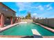 Backyard pool and spa with diving board and brick border, set against a two-story home and blue sky at 1009 N Tenaya Way, Las Vegas, NV 89128